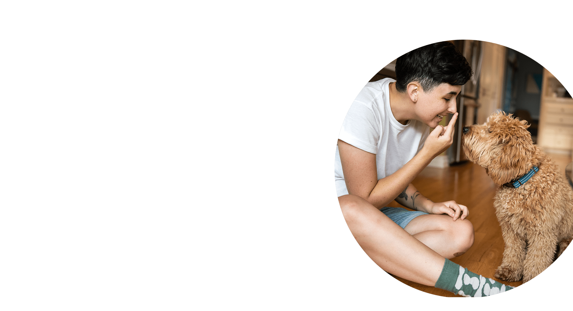 Seated teenage girl touching her nose and smiling to her dog